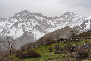 Snow-capped Mulhacen and Alcazaba mountains with old stone structures