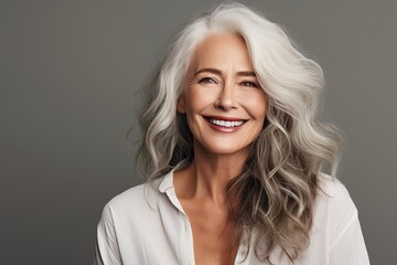 Fototapeta premium Senior aging mature confident woman with long gray hair and happy smiling