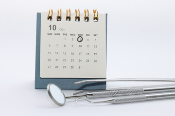 Calendar with the world dentist day marked with instruments used by dentists