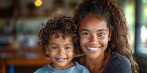 African mother and daughter share an affectionate embrace, smiling with joy and togetherness.