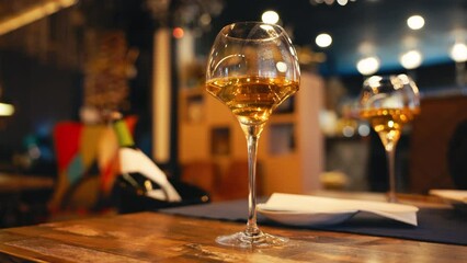 Delight in elegant ambiance with a glass of white wine in a sophisticated restaurant