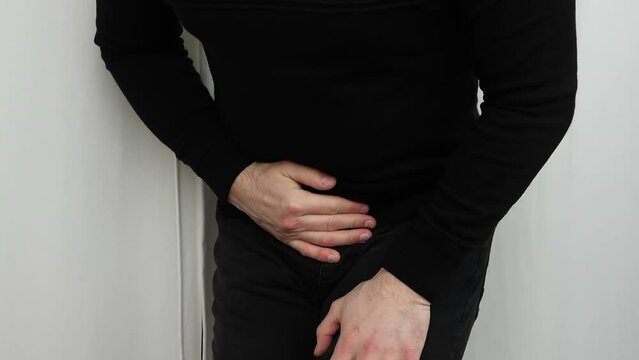 Pain in the genitourinary system. Urolithiasis in men. A man has pain in the groin, problems with prostate adenoma