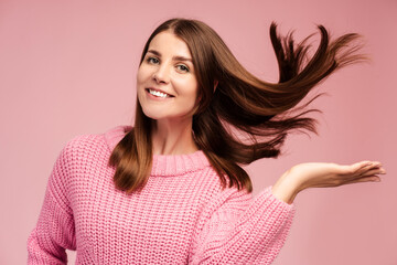Portrait of happy, attractive, smiling woman having beautiful hair, looking at camera