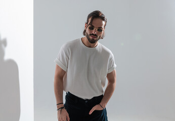 cool young man with sunglasses holding hand in pocket