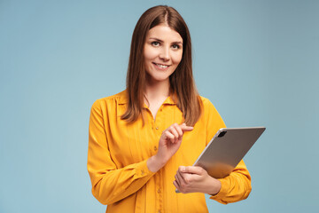 Fototapeta premium Successful, smiling, middle aged businesswoman holding digital tablet, checking email, text message