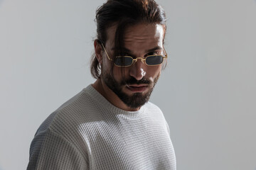 close up picture of cool bearded man with sunglasses looking at camera