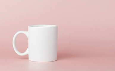 white cup for tea or coffee on a pink background