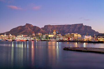 Obraz premium victoria & alfred v&a waterfront and table mountain in the background after sunset, Cape Town, South Africa