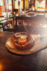 soft pretzel and three sauces at restaurant