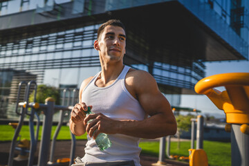 man young male athlete hold bottle of water drink training outdoor