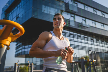 man young male athlete hold bottle of water drink training outdoor