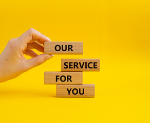 Our service for you symbol. Wooden blocks with words Our service for you. Beautiful grey background. Businessman hand. Business and Our service for you concept. Copy space.