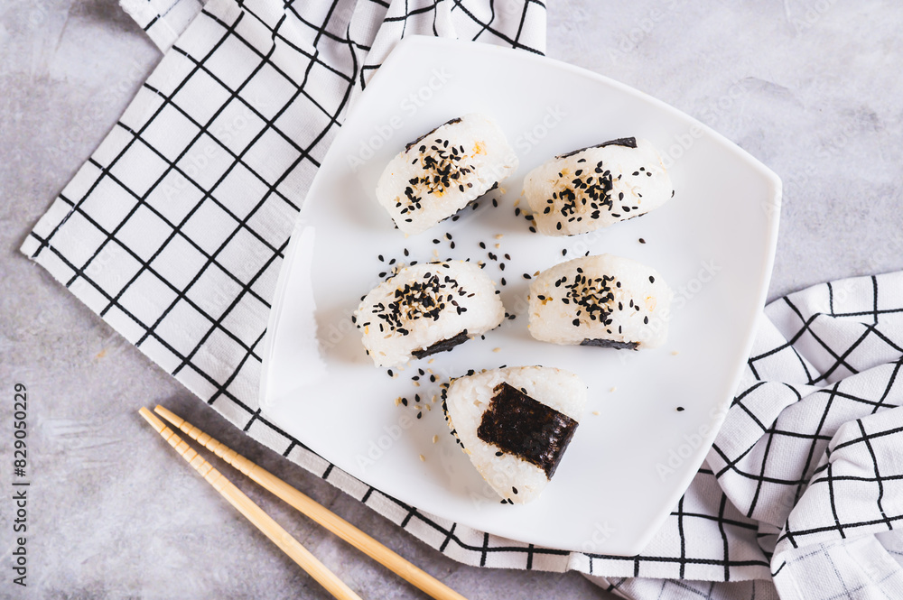 Wall mural close up of onigiri traditional japanese food of rice and tuna on a plate on the table top view