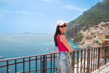 Young woman enjoying the view of Positano town on Amalfi coast in Italy .Travel concept 