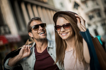 Happy couple shopping together in the city