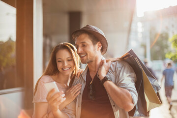 Happy couple shopping together in the city