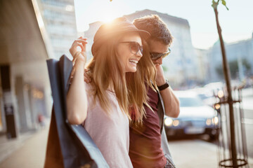 Happy couple shopping together in the city