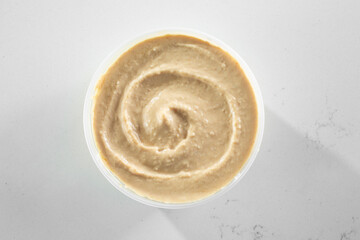 A top down view of a container of baba ganouj.