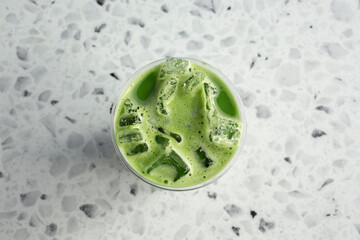 A top down view of a cold matcha iced tea drink. © DAVID