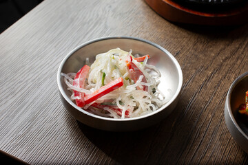 A view of a banchan bowl of cheonsachae salad.