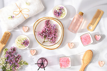 Spa and wellness composition with aromatic rose water, lilac water and lilac flowers, aromatherapy...