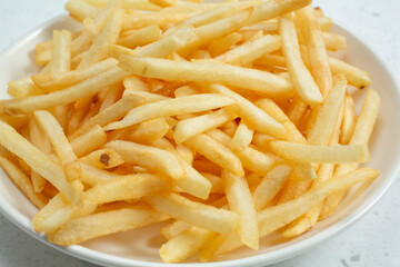 A closeup view of a bowl of French fries.