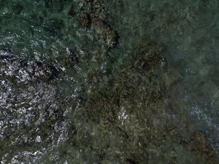 cenital view of the surface of the ocean in a coral reef and seagrass area of the caribbean in San Andres, Colombia