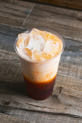 A view of a cold Thai tea beverage.