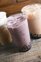 A view of a taro milk tea with boba.