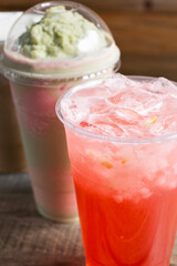 A view of a strawberry lychee drink and a strawberry avocado milk tea.