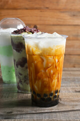 A view of a brown sugar milk tea, among other assorted milk tea beverages.