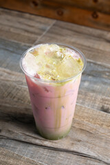 A view of a green and pink milk tea beverage.