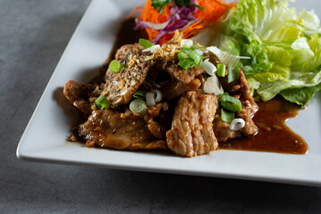 A view of a plate of garlic and pepper pork.