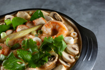 A closeup view of a bowl of tom kha goong.
