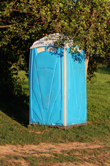 Used portable unisex blue with white top ecological toilet or portable chemical toilet mounted on...