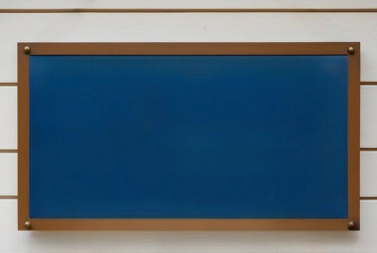 a blue board with space for text hanging on a wooden white background