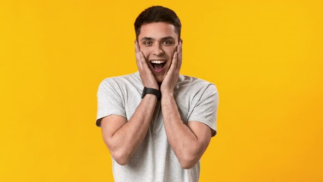 Shocked happy young guy looking at camera, feeling amazement and full disbelief