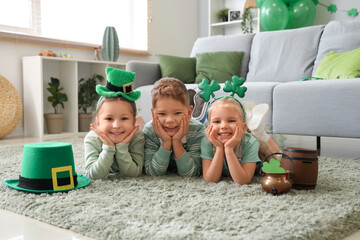 Cute kids celebrating St. Patrick's Day with festive green outfits at home party