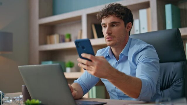 Frustrated employee reading mobile phone message. Closeup emotional boss receive