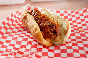 A view of a Nashville chicken sandwich on a bread roll.