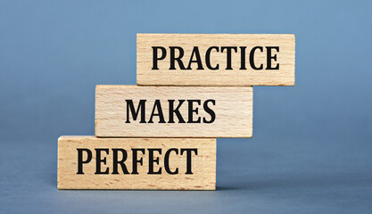 PRACTICE MAKES PERFECT - words on wooden blocks on blue background