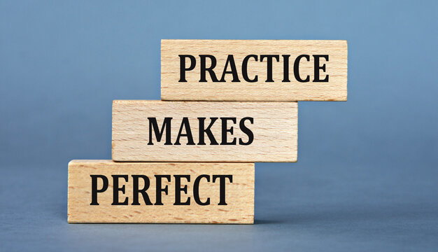 PRACTICE MAKES PERFECT - words on wooden blocks on blue background