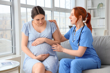 Worried young pregnant woman visiting doctor in clinic