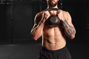 Man holding kettlebell in both hands. Routine workout for physical and mental health.