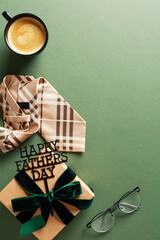 Happy Fathers Day vertical banner template. Vintage flat lay composition with gift box, coffee cup, tie, glasses on green background