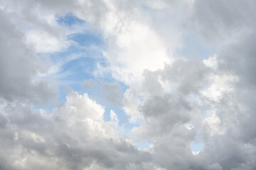 Dramatic sky of medium blue with bright white and gray clouds as a nature background
