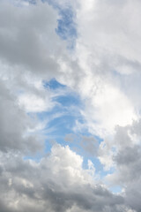Obraz premium Dramatic sky of medium blue with bright white and gray clouds as a nature background 