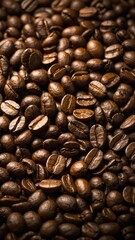 Fototapeta premium Multitude of roasted coffee beans captured in close-up image, filling frame. These beans showcase varying shades of brown, textures. Some beans display glossy sheen while others have matte finish.