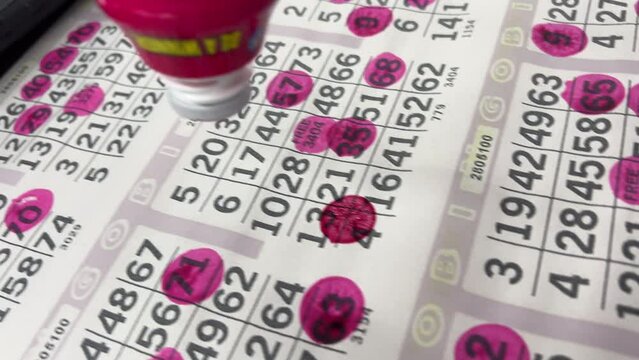 Playing bingo highlighting numbers on board 4k
