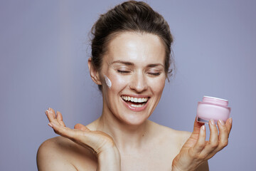 happy modern woman with cosmetic cream jar